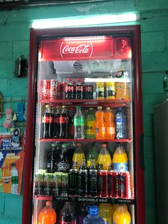 a vending machine filled with lots of different types of sodas and juice bottles