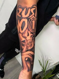 a man with a skull tattoo on his arm