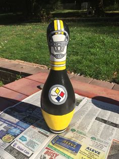 a bottle sitting on top of a newspaper