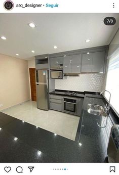 an empty kitchen with stainless steel appliances and black granite counter tops, is shown on instagram