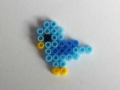 a blue bird made out of legos sitting on top of a white countertop