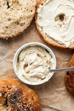 an assortment of bagels and cream cheese on paper