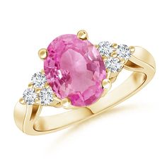 This prong set pink sapphire cocktail ring is designed in 14k yellow gold. The trio diamond accents flank the alluring oval pink sapphire for a luxurious look. Oval Sapphire Ring, Sapphire Cocktail Ring, Pink Sapphire Ring, Diamond Cocktail Rings, Pink Ring, Three Stone Rings, Cocktail Ring, Half Moon, Pink Sapphire