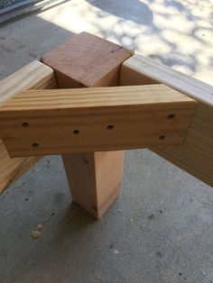 a wooden bench sitting on top of a sidewalk