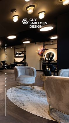 the interior of a hair salon with chairs and mirrors on the wall, lighting above