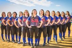 the softball team is posing for a group photo on the field in their uniforms and ready to play