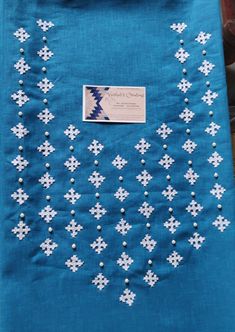 a blue table cloth with white crosses on it and a tag hanging from the side