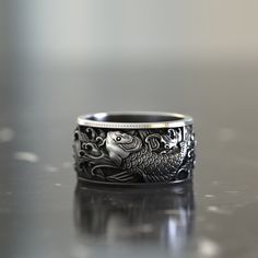 Japanese Koi Fish Band Ring, Handmade Men Ring, Mens Ring, Unique Ring for Man, Silver Signet Ring, Memorial Gift for Him 🎀 Admire the beauty and symbolism of our Japanese Koi Fish Band Ring. Crafted with precision, this silver signet ring is a unique accessory for men. Symbolizing resilience and strength, it's not just a fashion statement but also a meaningful memorial gift. Cherish the spirit of the koi fish with this remarkable piece of handmade jewelry. 🎀 ITEM DETAILS: *Gender : Male / Fem Japanese Rings Men, Japanese Rings, Japanese Koi Fish, Ring For Man, Fish Ring, Japanese Koi, Silver Signet Ring, Ring Mens, Men Ring