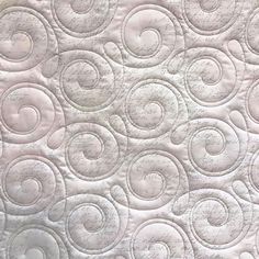 a close up view of a quilt with circles on it