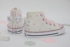 Perfect for any little princess, whatever the occasion!  Hi top Converse hand embellished with pale pink aurora borealis (rainbow) crystals and finished with iridescent white sequin bow backs, polka dot organza laces and our signature star charm on the laces. This styles features a single row of crystals around the sole. A double row of crystals are also available: https://www.etsy.com/uk/listing/1311907707/toddler-girls-custom-crystal-converse All shoes are authentic and made to order. Girls Wedding Shoes, Hi Top Converse, Converse Girls, Minnie Mouse Birthday Party Decorations, Painted Shoes Diy, Pink Aurora, Toddler Converse, Girls Converse, Iridescent White