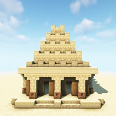 an image of a building made out of blocks in the desert with blue sky and clouds