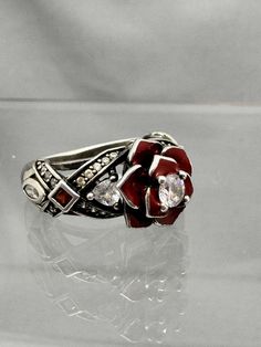 Beautiful Sterling Silver Vancaro red rose ring.   Size 5 1/2.   Weighs 5.13g If there is anything wrong once the item is received and you are not happy, please contact me before leaving negative feedback so we can resolve any issues. I strive for 100% happy buyers! Please leave positive feedback once item is received and all is well. Please feel free to ask me questions on my items! Return Policy: Buyer must contact me within 5 days of delivery to notify me of return and must ship with tracking insure within 7 days. Buyer pays return shipping and must return item with tracking. Once item is returned to me in it's original condition, a refund will be issued.