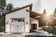 a small white house with a large garage