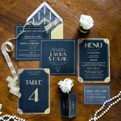 an assortment of wedding stationery items on a table