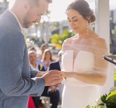 the bride and groom are exchanging their wedding vows