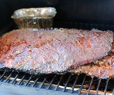 the meat is being cooked on the grill