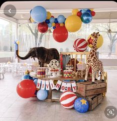 an elephant, giraffe and zebra are on display at a circus themed birthday party