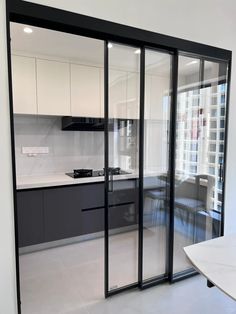 an empty kitchen and dining room with sliding glass doors