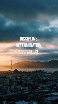 the sun is setting over a city with a bridge and mountains in the background that reads, discipline determination dedication