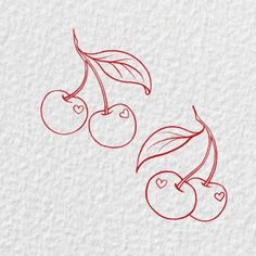 two cherries with leaves and hearts drawn on paper