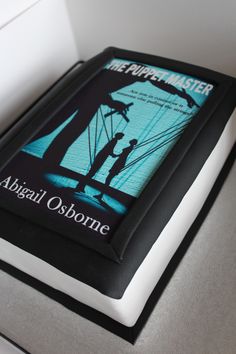 a book with an image of two people holding umbrellas on top of a table