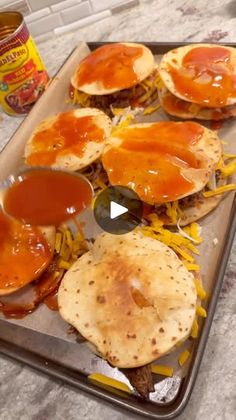 an image of some food that is on a tray with cheese and sauces in it