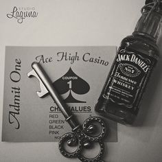 a bottle of jack daniels next to a pair of keys and a card with the ace high casino logo on it