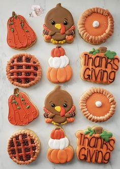 decorated cookies are arranged in the shape of turkeys, pumpkins and pies