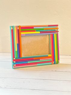 a multicolored photo frame sitting on top of a white table