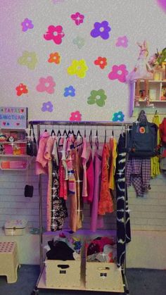 a room filled with lots of colorful clothing and accessories on display in front of a white wall