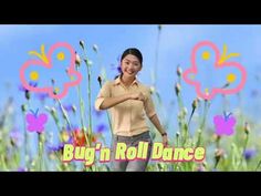 a woman standing in front of flowers with the words bug'n roll dance