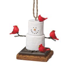 a snowman made out of toilet paper with birds perched on it