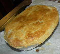 a piece of bread sitting on top of wax paper