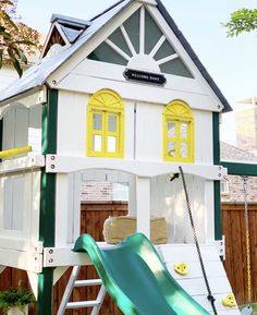 a play house with a slide in front of it