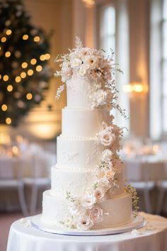 a white wedding cake with flowers on it