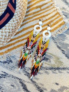 Artisan Beaded Fringe Earrings For Beach, Bohemian Tassel Earrings With Beaded Fringe, Traditional Beaded Fringe Earrings For Summer, Traditional Beaded Fringe Earrings For Beach, Bohemian Heishi Beads Earrings For Beach, Bohemian Heishi Beaded Earrings With Dangling Beads, Bohemian Multicolor Heishi Beads Earrings, Bohemian Multicolor Beaded Fringe Tassel Earrings, Bohemian Beaded Earrings With Dangling Heishi Beads