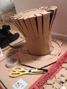 a pair of scissors sitting on top of a cardboard box next to some construction materials