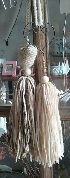 two tassels hanging from a wooden pole