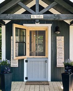 the front door of a house with two potted plants on the porch and a welcome sign