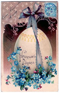 an easter egg with blue flowers and a bow on it's head is shown