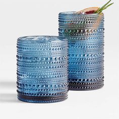 two blue vases sitting next to each other