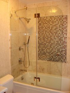 a bathroom with a toilet, bathtub and shower stall is shown in this image