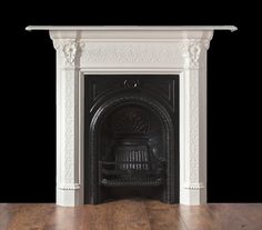 a white fireplace with wood floors and black walls