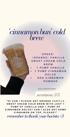 a person holding up a cup with the words cinnamon bun cold brew