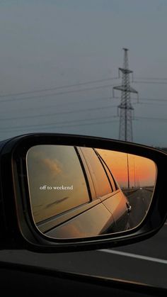 the rear view mirror of a car is reflecting an image of power lines in it