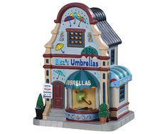 a small toy store with umbrellas on the front and side of it's building