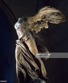 an angel statue with its wings spread out