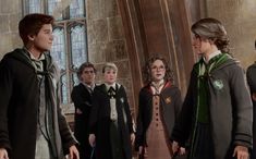 harry potter and the goblet of fire are standing in front of an old building