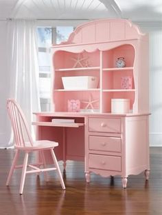 a pink desk and chair in a room