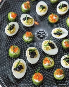 an assortment of deviled eggs with black cavia